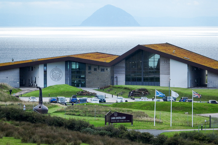 Lagg Distillery, Distillery of the Year 2023, with Ailsa Craig behind.