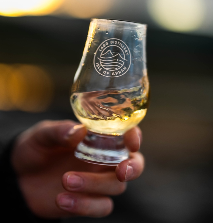 Hand holding a Glencairn whisky glass